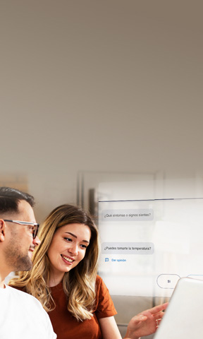 Two people sitting reviewing information on a computer.